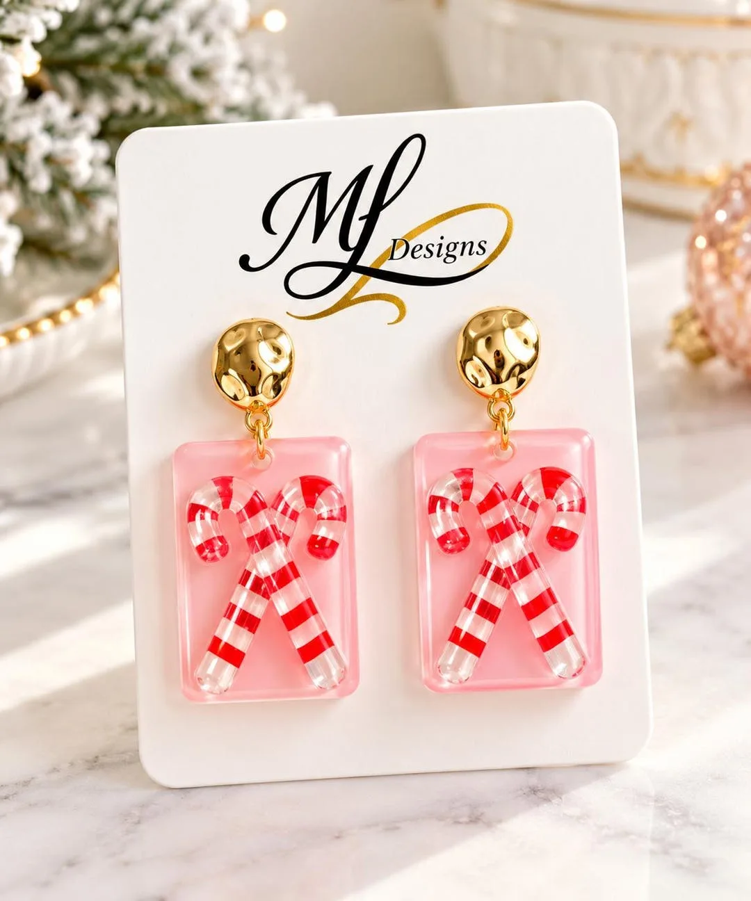 Pink resin earrings with red and white candy canes